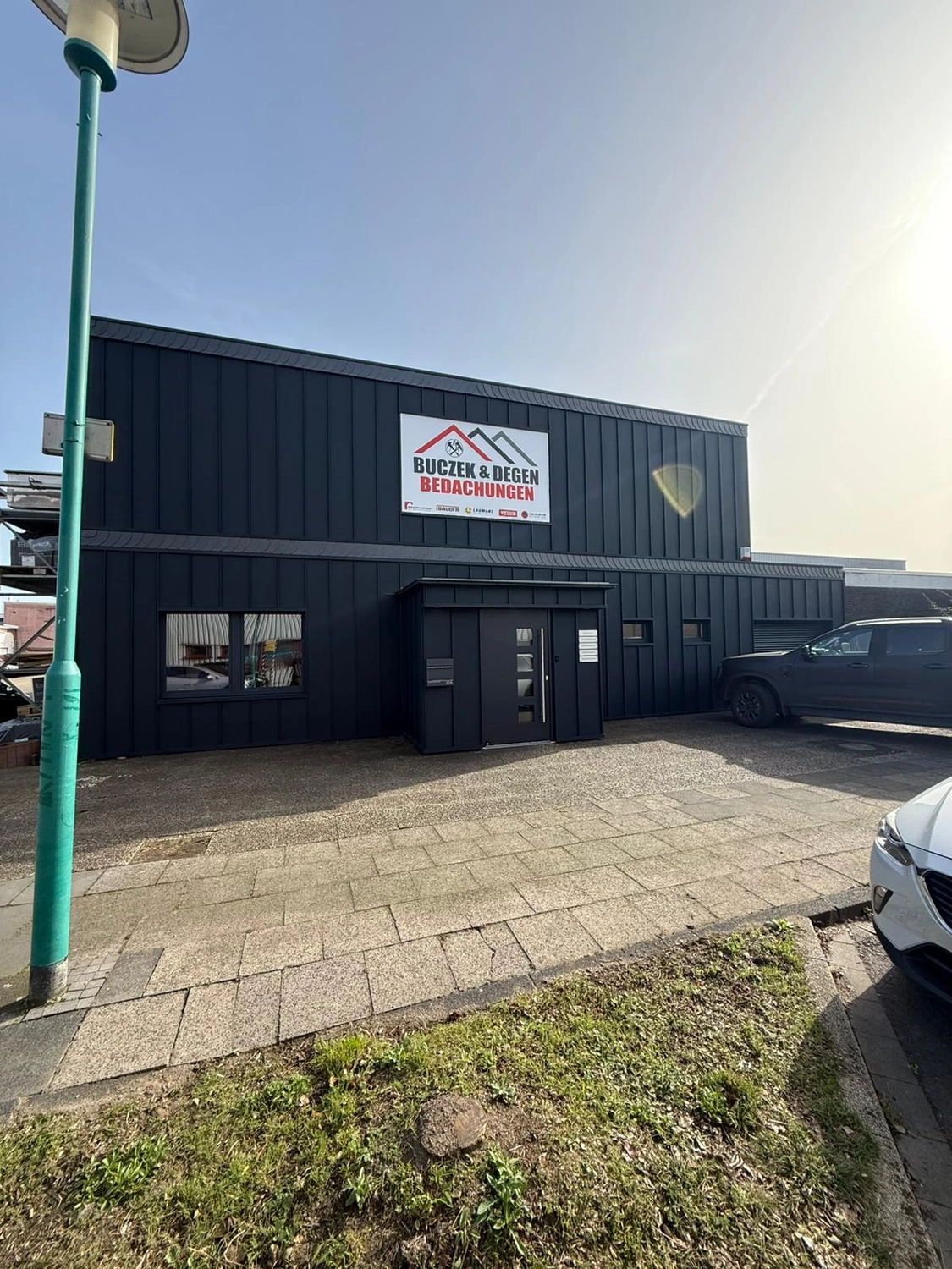 Buczek & Degen Bedachungen Gmb - Dachdeckermeisterbetrieb - Firmenlogo auf Firmengebäude